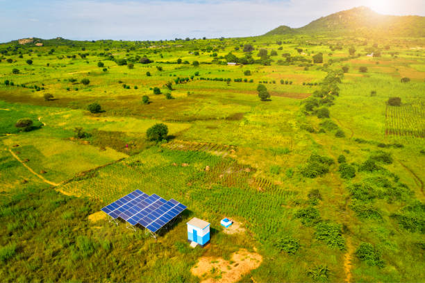 project3 Aerial drone shot of solar panels as a renewable energy source in remote areas of Tanzania, Africa plays a central role in development of sustainable resources. The solar power panels providing green energy stand out in the beautiful African savannah